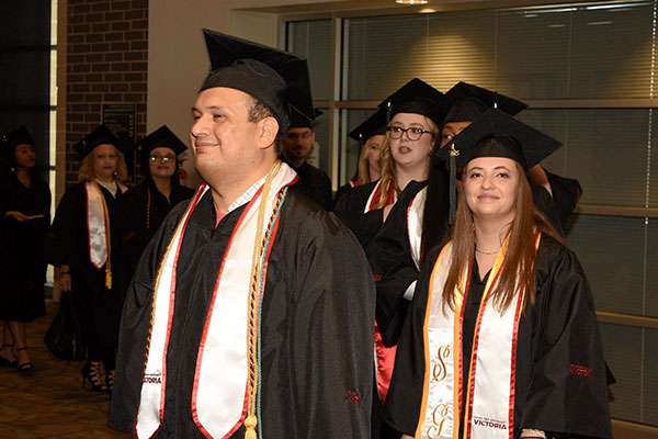 Graduating students getting ready to walk the stage