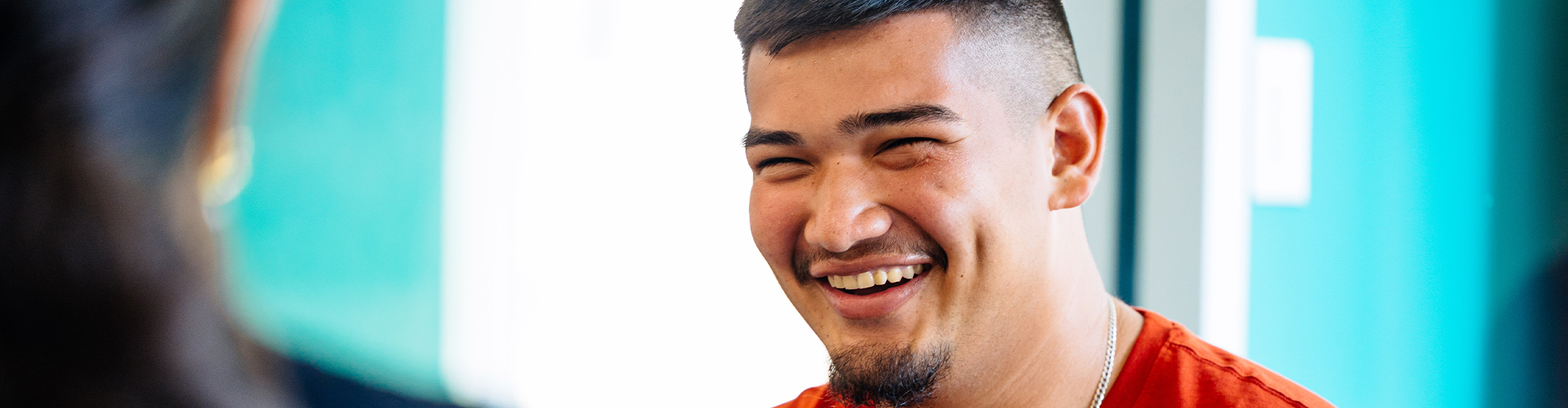 Student smiling at someone off camera.
