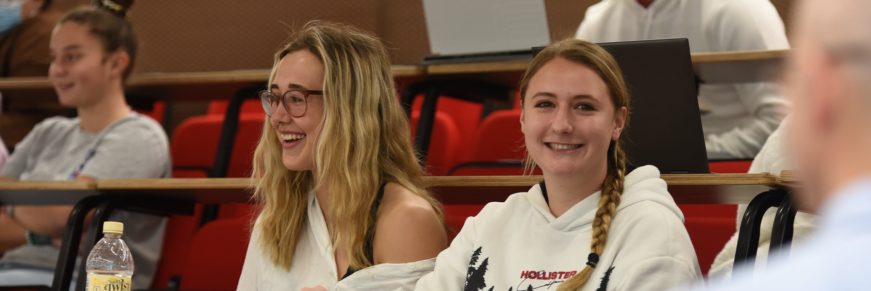 groups of students attend class in lecture hall