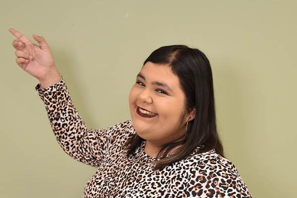 Student smiling and pointing