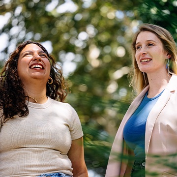 Student and faculty member smiling together