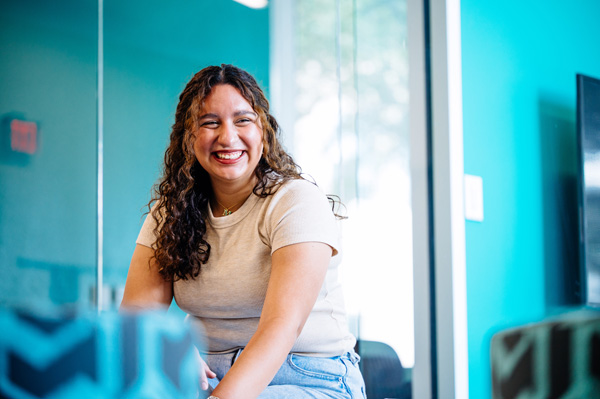Student sitting and smiling on Texas A&M University-Victoria campus