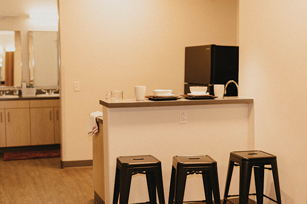 A shared living space and kitchenette in the dorms.