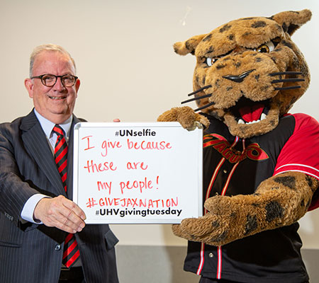 Bob Glenn and jaX pose for a photo for Giving Tuesday